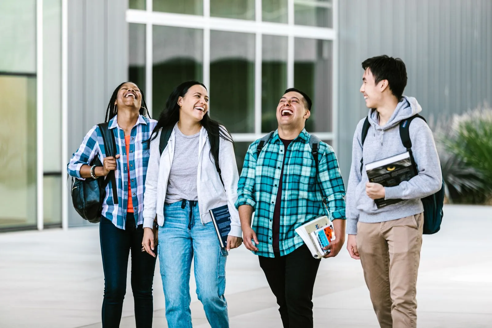 Students walking and laughing together outside class
